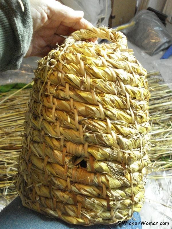 Rustic, coiled, straw bee skep woven by Cathryn Peters.