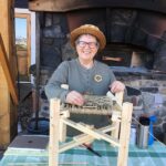 Cathryn Peters demonstrating how to weave a checkerboard seagrass stool as part of her Artist in Residence at North House Folk School in Grand Marais, MN.