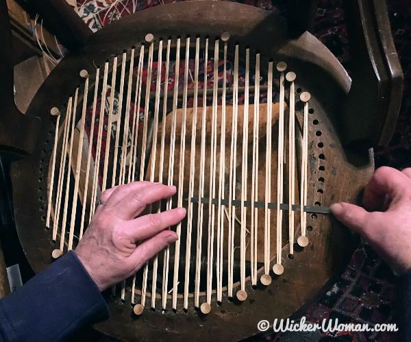 Cathryn weaving a round hole cane seat using an English chair caning steamer.