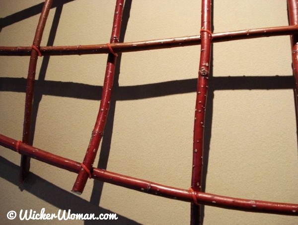 Detail of Red Fish, a large, flat, red dogwood basketry wall art by Cathryn Peters.