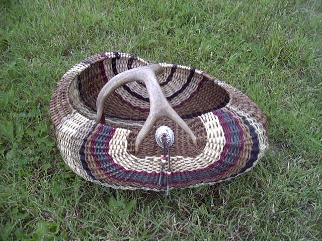 Antler basket, melon style with naturally shed blacktail antler, dyed and natural rattan reed, conch, and beads, commission basket woven by Cathryn Peters