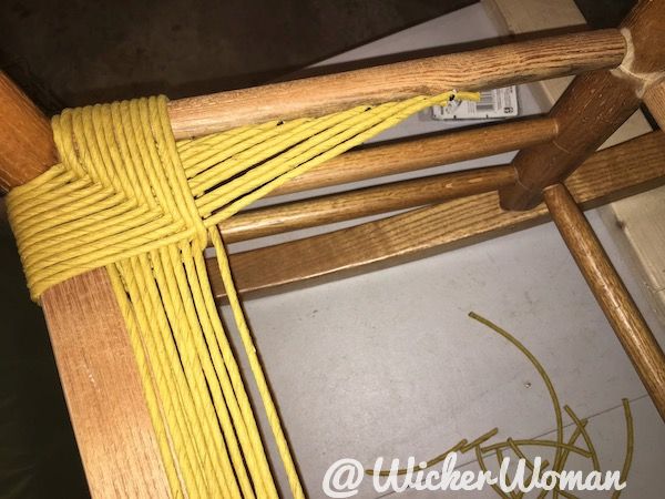 Paper rush end strands tacked to inside left seat rail.