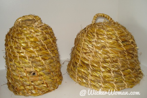 Two decorative rye straw bee skeps woven by Cathryn Peters as class samples.