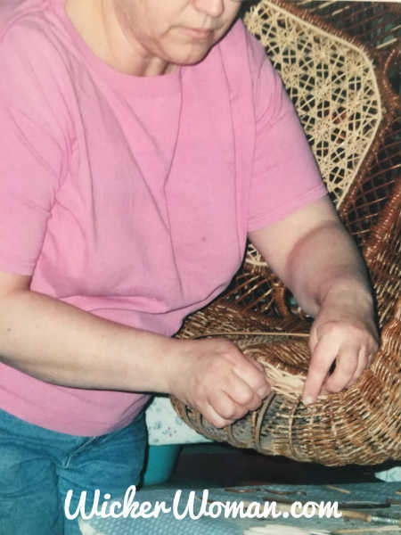 Cathryn repairing reed serpentine arm in Victorian wicker rocker