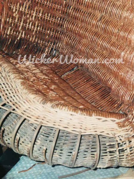 Spokes have been replaced and weaving serpentine reed wicker arm is beginning in Victorian wicker rocker