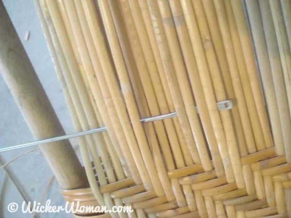 Bottom view of wide binding cane seat using a 4x4 twill weaving pattern.